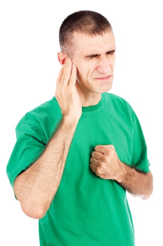 Man suffering from TMJ pain