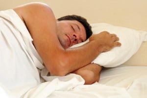 Mature man sleeping in his bed