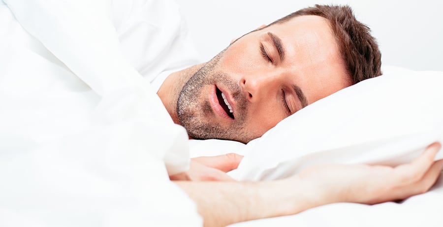 Man in bed snoring