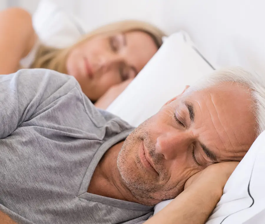 A peacful couple sleeping without the distraction and snoring of sleep apnea