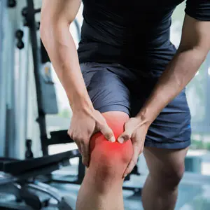 athletic man suffering from knee pain